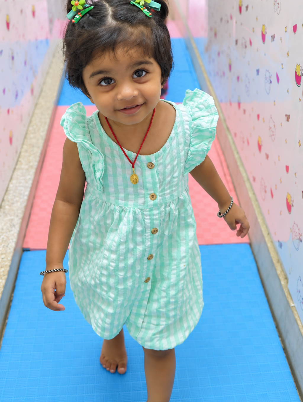 Toddler walking on soft play mats in the daycare